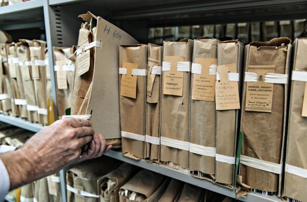 Package is pulled down from archive shelf containing old booklets and pamphlets